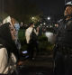 Pro-Palestine student activists face off with New York Police Department officers during a raid on Columbia University's campus at the request of Columbia University President Minouche Shafik on Tuesday evening, April 30, 2024 in New York. NYPD officers, including those from the police department's Strategic Response Group, arrested approximately 100 people as they dismantled encampments and removed individuals occupying Hamilton Hall. (Seyma Bayram via AP)