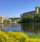 FILE - Men fish near the fortresses of Narva, left, in Estonia, and Ivangorod, right, in Russia, on Wednesday, May 24, 2023. The EU foreign policy chief Josep Borrell says the removal of 25 Estonian buoys by Russian border guards on a river separating the Baltic country from Russia was “unacceptable.” (AP Photo/Jim Heintz, File)