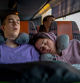 transport, tourism, road trip and people concept - happy teenage couple or tourists sleeping on shoulder in travel bus