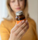 Woman holding supplement bottle
