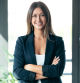 Portrait of beautiful young business woman standing while smiling looking at camera in the office.