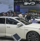 FILE - Visitors look at cars at the BYD booth during the China Auto Show in Beijing, China, Friday, April 26, 2024. The European Union threatened on Wednesday, june 12, 2024, to hike tariffs on Chinese electric vehicles, escalating a trade dispute over Beijing's subsidies for the exports that Brussels worries is hurting domestic automakers. (AP Photo/Tatan Syuflana, File)