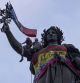 Statue of Republique plaza is decorated by flags as people gather at a protest against the far-right, Wednesday, July 3, 2024 in Paris. French opposition parties and associations are trying to block a landslide victory for Marine Le Pen's far-right National Rally in next Sunday's second round of legislative elections. (AP Photo/Louise Delmotte)