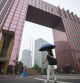 A Chinese walks past central business district in Beijing, China, Tuesday, July 2, 2024. Surveys of Chinese factory managers showed a mixed outlook for the world's second-largest economy in June, with growth steady but not picking up much steam. (AP Photo/Vincent Thian)