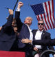 Republican presidential candidate former President Donald Trump gestures as he is surrounded by U.S. Secret Service agents as he leaves the stage at a campaign rally, Saturday, July 13, 2024, in Butler, Pa. (AP Photo/Evan Vucci)