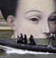 Members of police forces patrol on a boat along the Seine river next to a pannel depicting a pictorial detail ahead of the opening ceremony of the Paris 2024 Olympic Games, in Paris, on July 23, 2024. (Photo by SEBASTIEN BOZON / AFP)