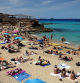 Tourists sunbathe at Cala Comte (Comte beach) in Sant Josep de sa Talaia, on the Balearic island of Ibiza, on May 16, 2024. (Photo by Thomas COEX / AFP)