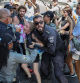 TOPSHOT - Policemen scuffle with a protester as families and supporters of Israeli hostages held by Palestinian militants in the Gaza Strip since October hold a rally calling for their release in Tel Aviv on September 2, 2024, amid the ongoing conflict in the Gaza Strip between Israel and the Palestinian militant Hamas movement. (Photo by Jack GUEZ / AFP)
