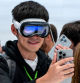 An attendee wearing an Apple Vision Pro with the Apple iPhone 16 Pro during an event at Apple Park campus in Cupertino, California, US, on Monday, Sept. 9, 2024. Apple Inc.introduced the latest version of its flagship device, the iPhone 16, betting it can entice consumers with modest hardware upgrades and AI technology that#{emoji}146;s still on the horizon. Photographer: David Paul Morris/Bloomberg