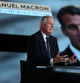 France's Prime Minister Michel Barnier speaks next to a screen displaying a picture of French President Emmanuel Macron during the political TV show 