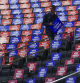 A worker places signs in seats before Republican presidential nominee former President Donald Trump speaks at a campaign rally at Madison Square Garden, Sunday, Oct. 27, 2024, in New York. (AP Photo/Julia Demaree Nikhinson)