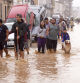 People walk through flooded streets in Valencia, Spain, Wednesday, Oct. 30, 2024. (AP Photo/Alberto Saiz)