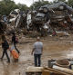 VALENCIA, SPAIN - NOVEMBER 04: A man looks at a pile of car after heavy rain and flooding hit large parts of the country on November 04, 2024 in Alfafar municipality, in Valencia, Spain. By Friday, Spanish authorities confirmed that at least 200 people had died, mostly in the Valencia region, amid the flooding that swept eastern and southern parts of the country starting on Tuesday. The intense rainfall event is known as a 