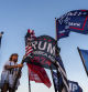 Nikki Fuller, 56, sets up flags on her truck near the Mar-a-Lago estate of President-elect Donald Trump, Monday, Nov. 11, 2024, in Palm Beach, Fla. (AP Photo/Julia Demaree Nikhinson)