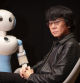 Retrat d'Hiroshi Ishiguro amb un dels seus robots al Cosmocaixa de Barcelona. 04-11-2024. Foto: Miquel Muñoz / Shooting.
