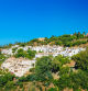 Panorama of Village With Whitewashed Houses In Benahavis, Malaga, Andalusia, Spain. Summer Cityscape. Sunny Day With Good Weather and Clear Blue Sky