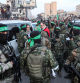 TOPSHOT - Members of the International Committee of the Red Cross (ICRC) speak with fighters of the Ezzedine al-Qassam Brigades, Hamas's armed wing, in Saraya Square in western Gaza City on January 19, 2025. The Israeli military said the Red Cross had confirmed the handover of three hostages on January 19, the first to be released as part of a ceasefire deal with Hamas. The Hostage and Missing Families Forum campaign group had identified the three women set to be released as Emily Damari, Romi Gonen and Doron Steinbrecher, seized during Hamas's October 7, 2023 attack that triggered the war. (Photo by Omar AL-QATTAA / AFP)