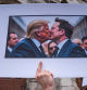 A protester holds a sign with an AI image depicting President Donald Trump and tech billionaire Elon Musk during a 50501 Movement protest against Project 2025 and the executive orders of U.S. President Donald Trump, on Broadway in Nashville, Tennessee, U.S., February 5, 2025. REUTERS/Seth Herald