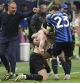 Inter Milan players celebrate in fron ot Barcelona's head coach Hansi Flick during the Champions League semifinal second leg soccer match between Inter Milan and Barcelona at San Siro stadium in Milan , Italy, Tuesday, May 6, 2025. (AP Photo/Antonio Calanni)