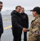 TOPSHOT - French President Emmanuel Macron (2L) shakes hands with a military personnel flanked by Prime Minister of Greenland Jens-Frederik Nielsen (L) and Denmark's Prime Minister Mette Frederiksen (R) on board the Danish frigate F363 Niels Juel in Nuuk, Greenland, on June 15, 2025. French President Emmanuel Macron arrived on June 15 in Greenland, where he is expected to express 