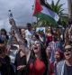 People shout slogans as they bid farewell to activists setting sail on their boats to join a civilian flotilla bound for Gaza, with the aim of breaking the Israeli blockade and delivering humanitarian aid, in Barcelona, Spain, on Sunday, August 31, 2025. (AP Photo/Emilio Morenatti)
