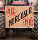 A tractor bearing a sign reading #{emoji}147;No Mercosur no#{emoji}148; is driven as Spanish farmers hold a protest against the EU-Mercosur trade deal and the economic pressures facing the agricultural sector in Burgos, northern Spain, on January 16, 2026. (Photo by CESAR MANSO / AFP)