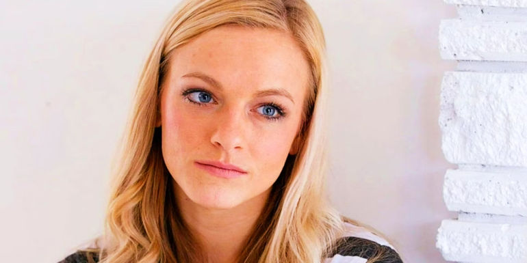 A young MacKenzie McKee from Teen Mom with serious expression in front of white fireplace