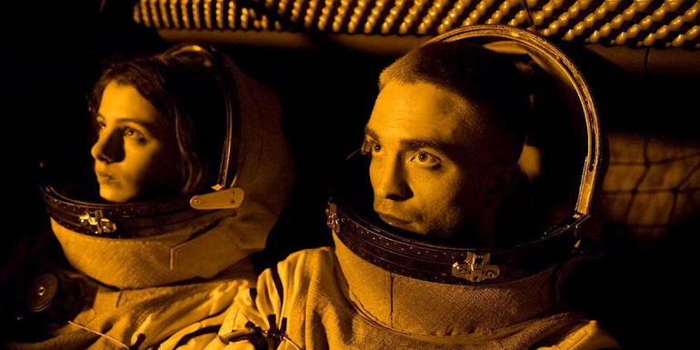 Monte and Willow are in their space suits and are looking into the light in High Life.