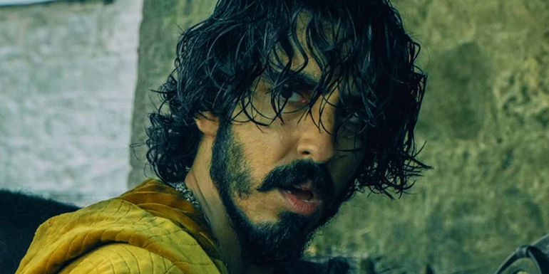 Dev Patel with long hair in The Green Knight