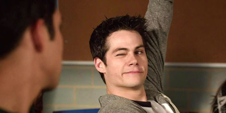 Dylan O'Brien winking and raising his hand in Teen Wolf