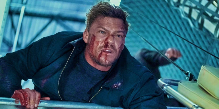 Alan Ritchson as Reacher holding Dixon's guerney in Reacher season 2 finale