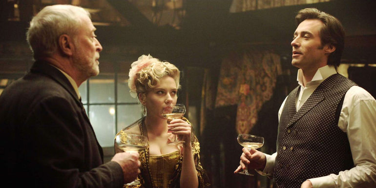 Michael Caine, Scarlett Johansson as Olivia Wenscombe, and Hugh Jackman as Robert Angier looking in The Prestige