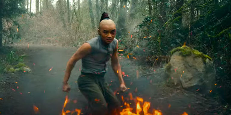  Dallas Liu as Prince Zuko standing in fire in Netflix's Avatar: The Last Airbender