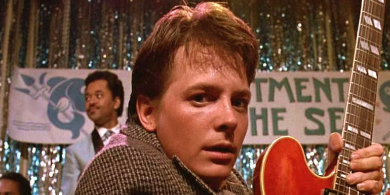 A closeup on Marty while he plays the guitar in Back to the Future