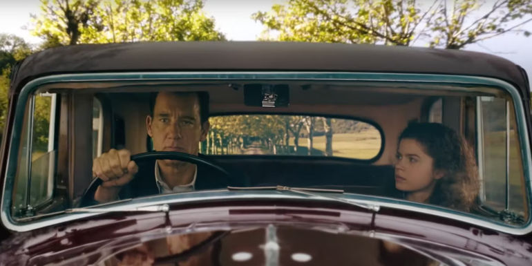 Clive Owen as Sam Spade driving with a young girl in the passenger seat in Monsieur Spade.
