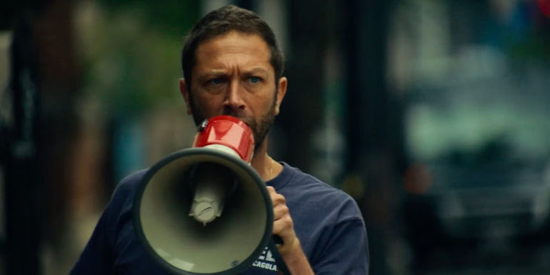 Richie yelling at crowd with megaphone 
