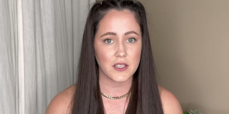 Jenelle Evans from Teen Mom sits in front of white curtain with concerned facial expression