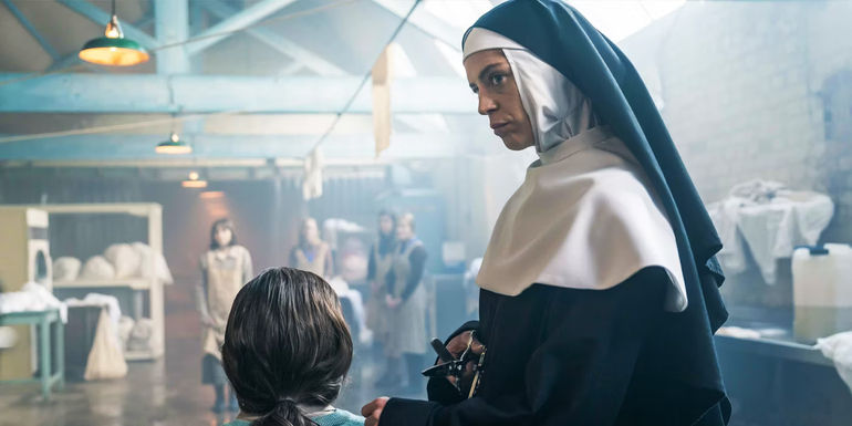 Aoibhinn McGinnity as Young Sister Eileen holding a child by the hand in The Woman In The Wall