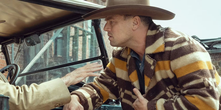 Leonardo DiCaprio as Ernest Burkhart looking troubled at night in Killers of the Flower Moon