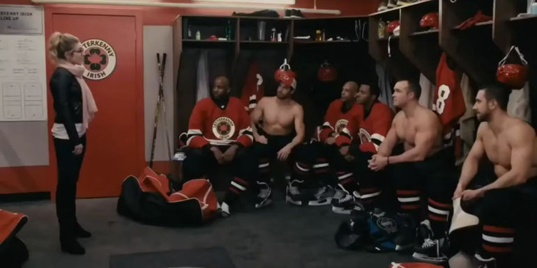 Angie (Kalinka Petrie) as a Puck Bunny in Letterkenny speaking to the hockey team.