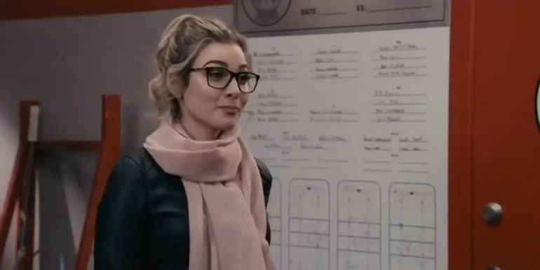 Angie (Kalinka Petrie) as a Puck Bunny in Letterkenny standing in the locker room.