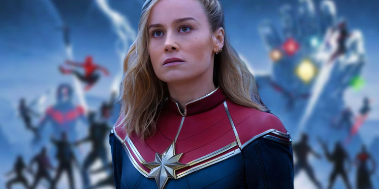 Brie Larson looking perplexed as Captain Marvel in The Marvels above a blurred poster for the MCU's Infinity Saga