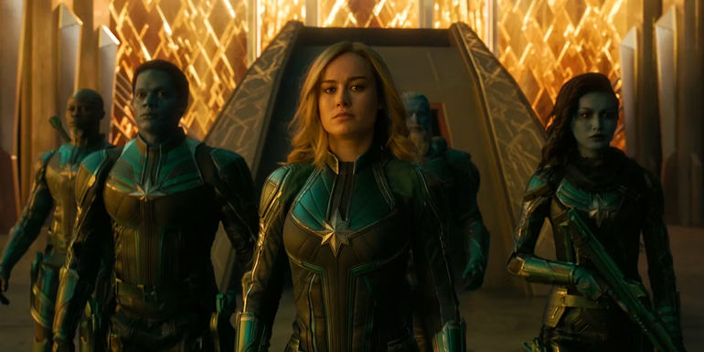 Brie Larson as Carol Danvers walking with Kree warriors in Captain Marvel (2019)