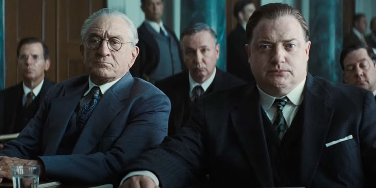 Robert De Niro as William Hale and Brendan Fraser as W. S. Hamilton sit in court in Killers of the Flower Moon