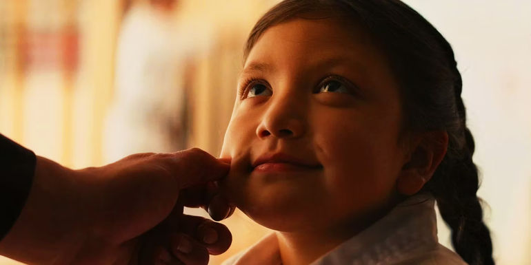 Young Maya Lopez having her cheek squeezed by Kingpin