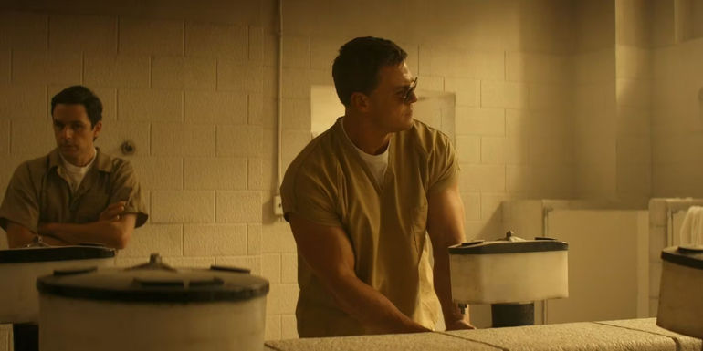 Jack Reacher wears sunglasses in a prison bathroom