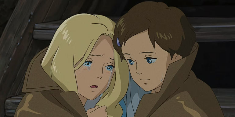 Two young girls comfort each other from the film When Marnie Was There 