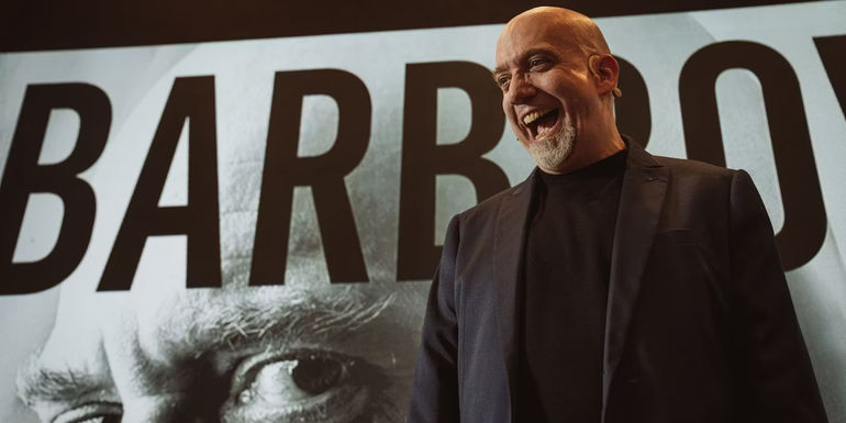 Paul Giamatti as Christian Barbrow shouting happily in front of a billboard of himself in 30 Coins season 2.