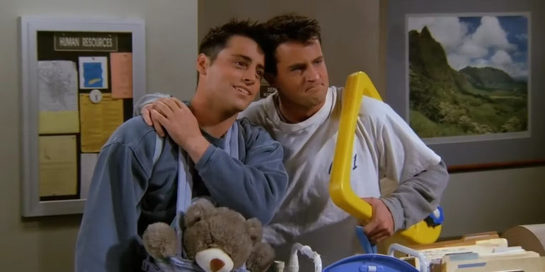 Chandler and Joey leaning on each other in Friends