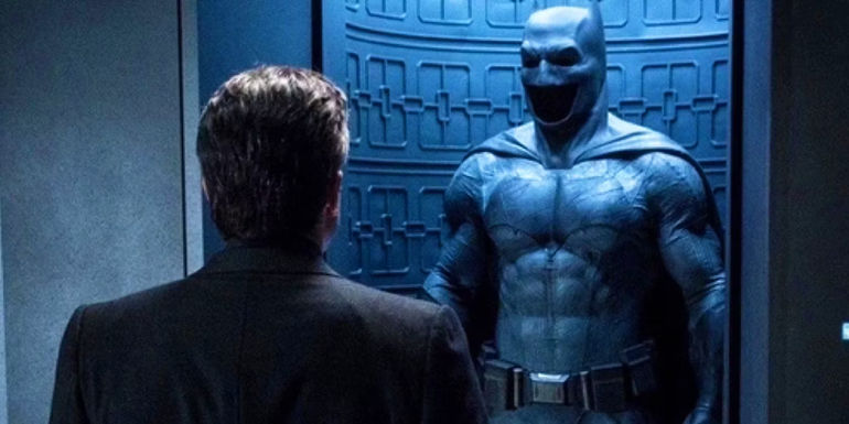 Ben Affleck's Batman looks at his DCEU Batsuit in Batman v Superman: Dawn of Justice